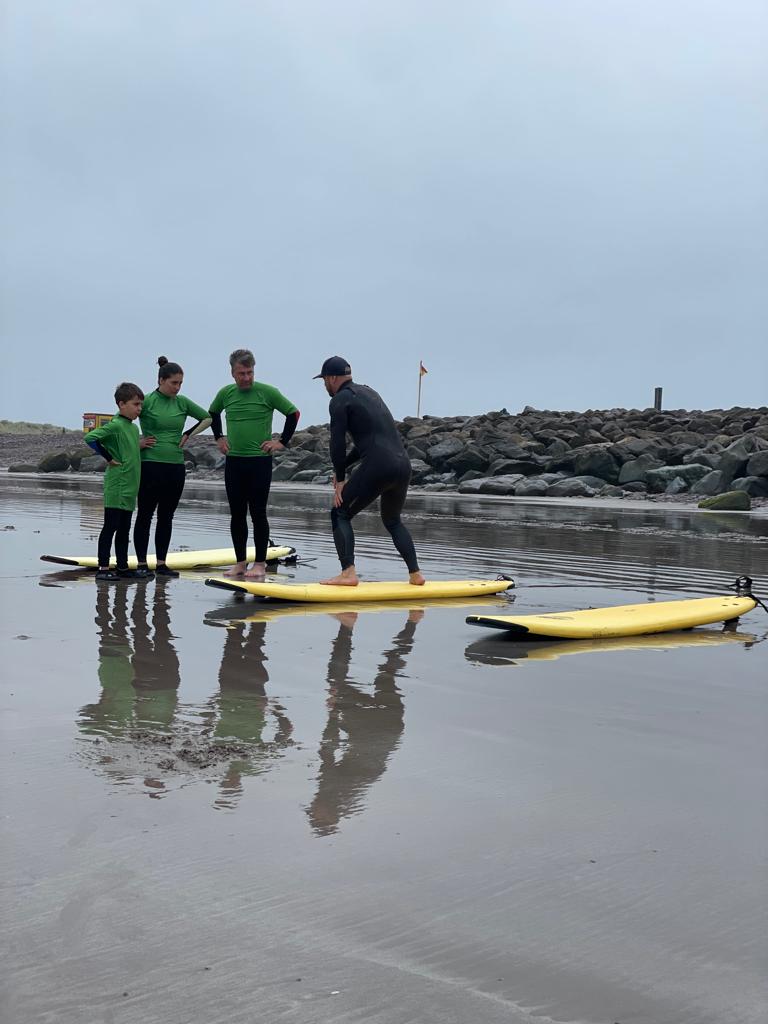 Oscar demonstrating surfing techniques to a onlooking group